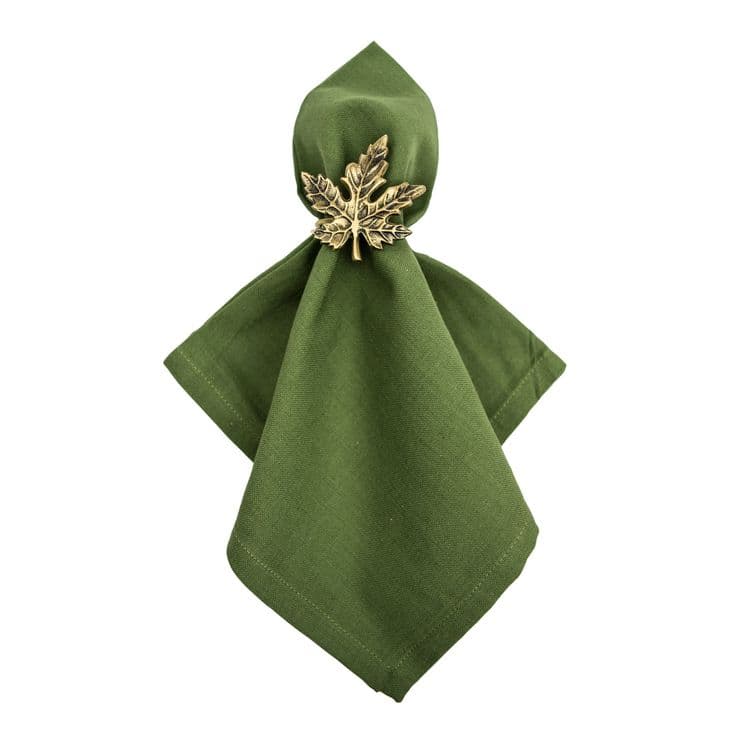 a green napkin with a gold leaf on it